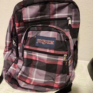 JanSport pink and black plaid large backpack.